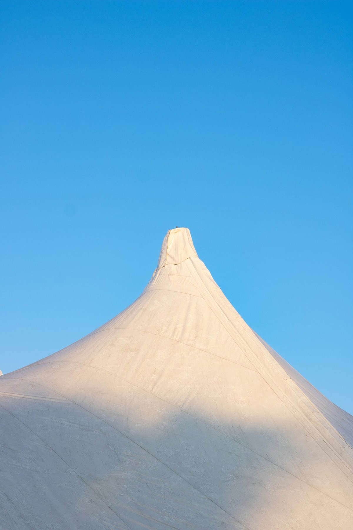 White event tent against a blue sky